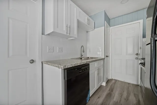 a kitchen with stainless steel appliances granite countertop a stove and a refrigerator