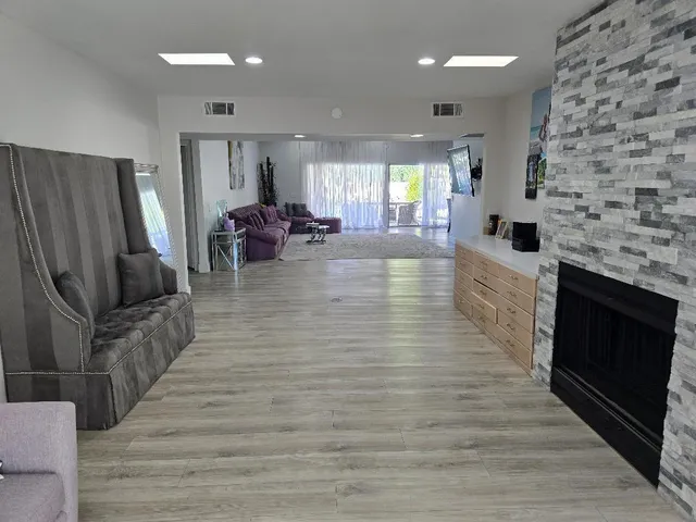 a living room with furniture wooden floor and a fireplace