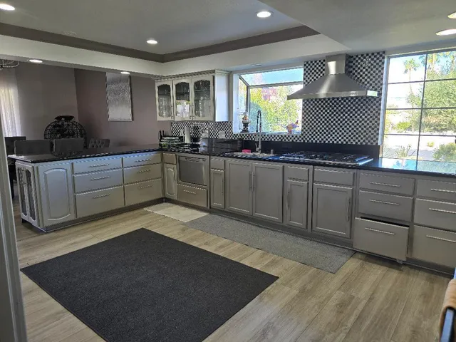 a kitchen with a sink cabinets and window