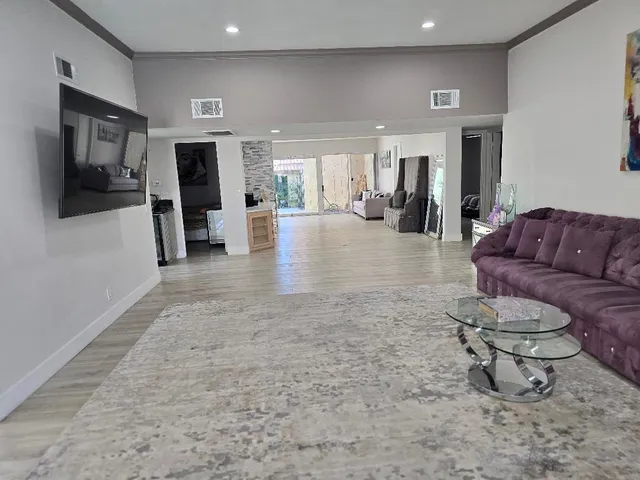 a lobby with furniture and a flat screen tv
