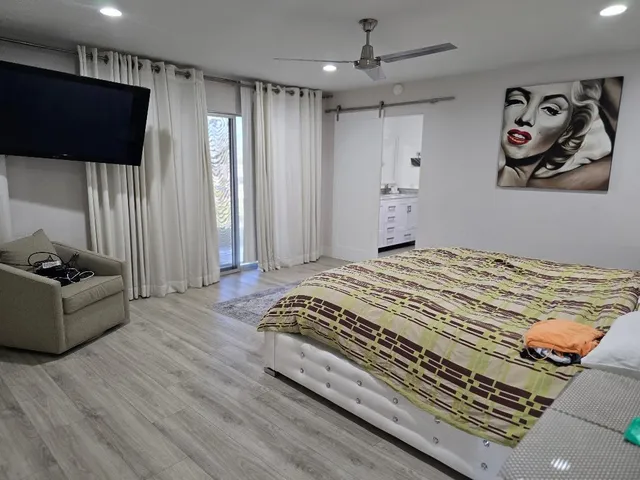 a bedroom with a bed and a television