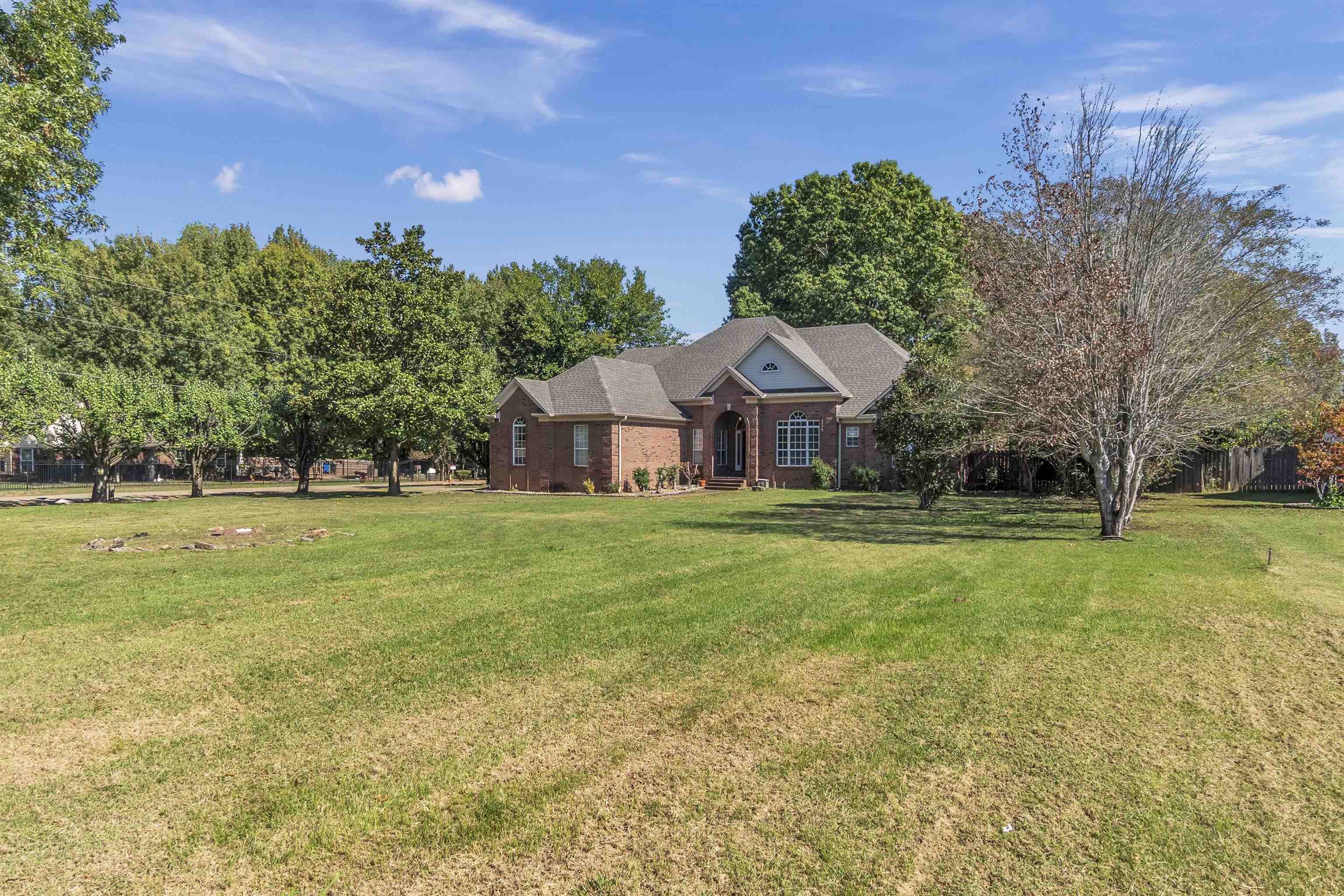 View of front of home featuring a front yard and brick siding