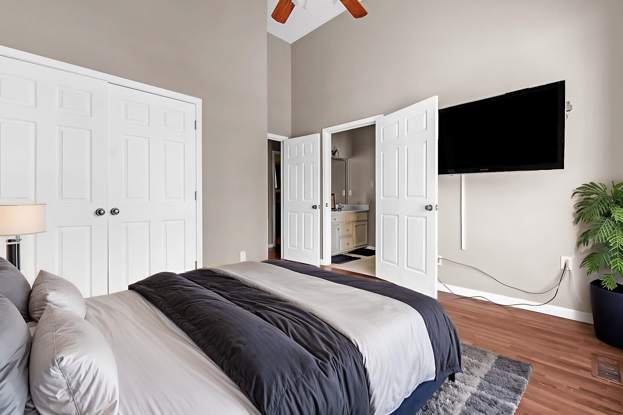 4366 Campground Road Munford, TN 38058 - Photo 27 of 40 Bedroom with wood finished floors, a high ceiling, connected bathroom, a ceiling fan, and a closet