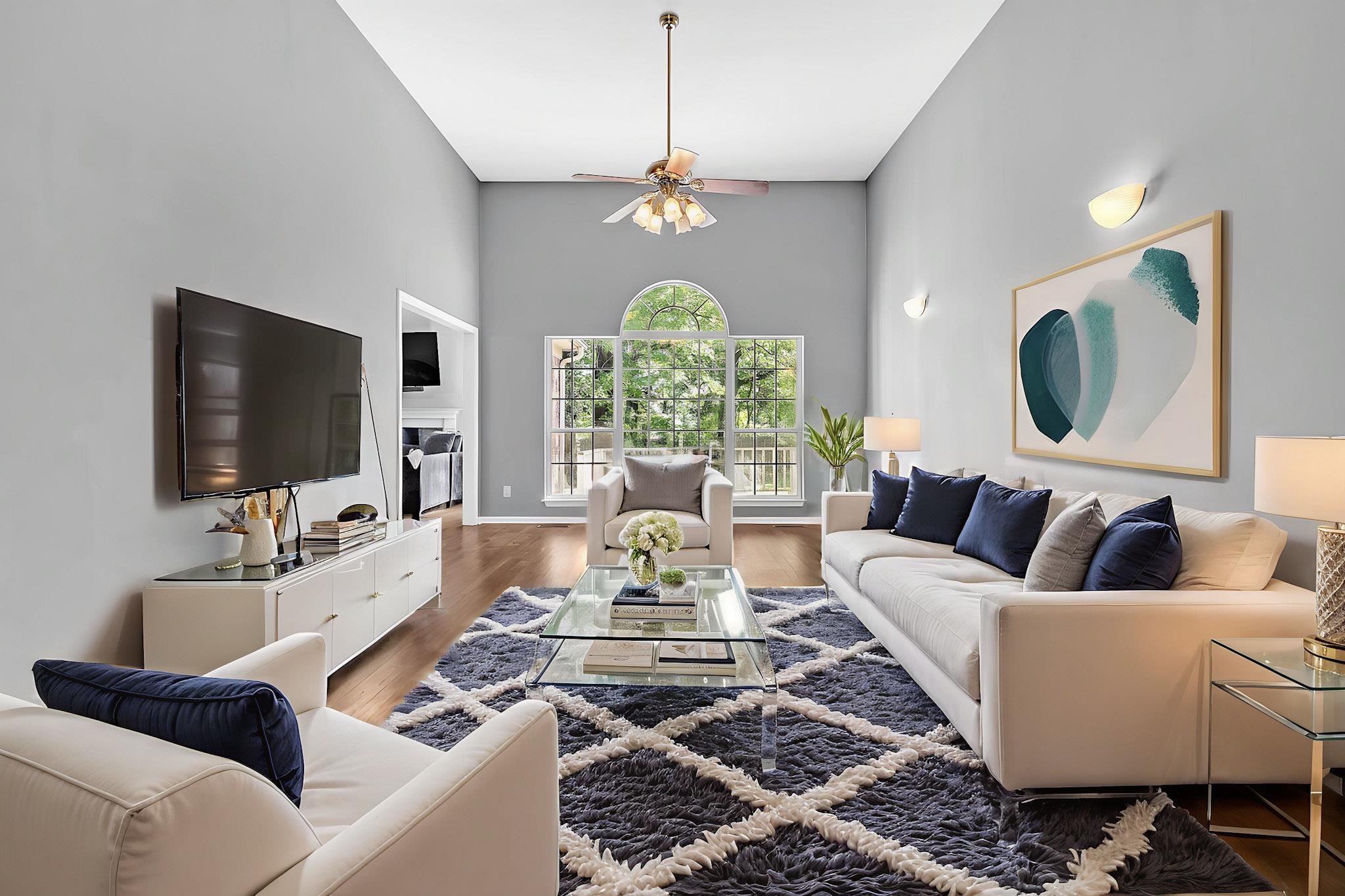 4366 Campground Road Munford, TN 38058 - Photo 3 of 40 Living room featuring wood finished floors, a ceiling fan, a fireplace, and a high ceiling