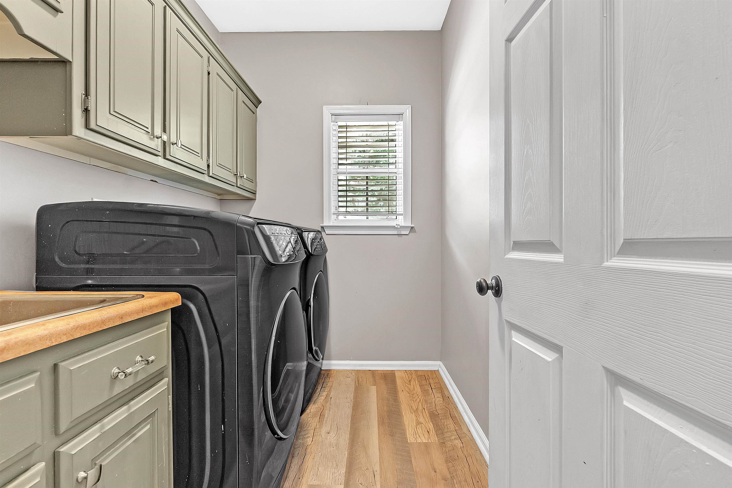 4366 Campground Road Munford, TN 38058 - Photo 33 of 40 Washroom featuring independent washer and dryer, light wood-style flooring, and cabinet space