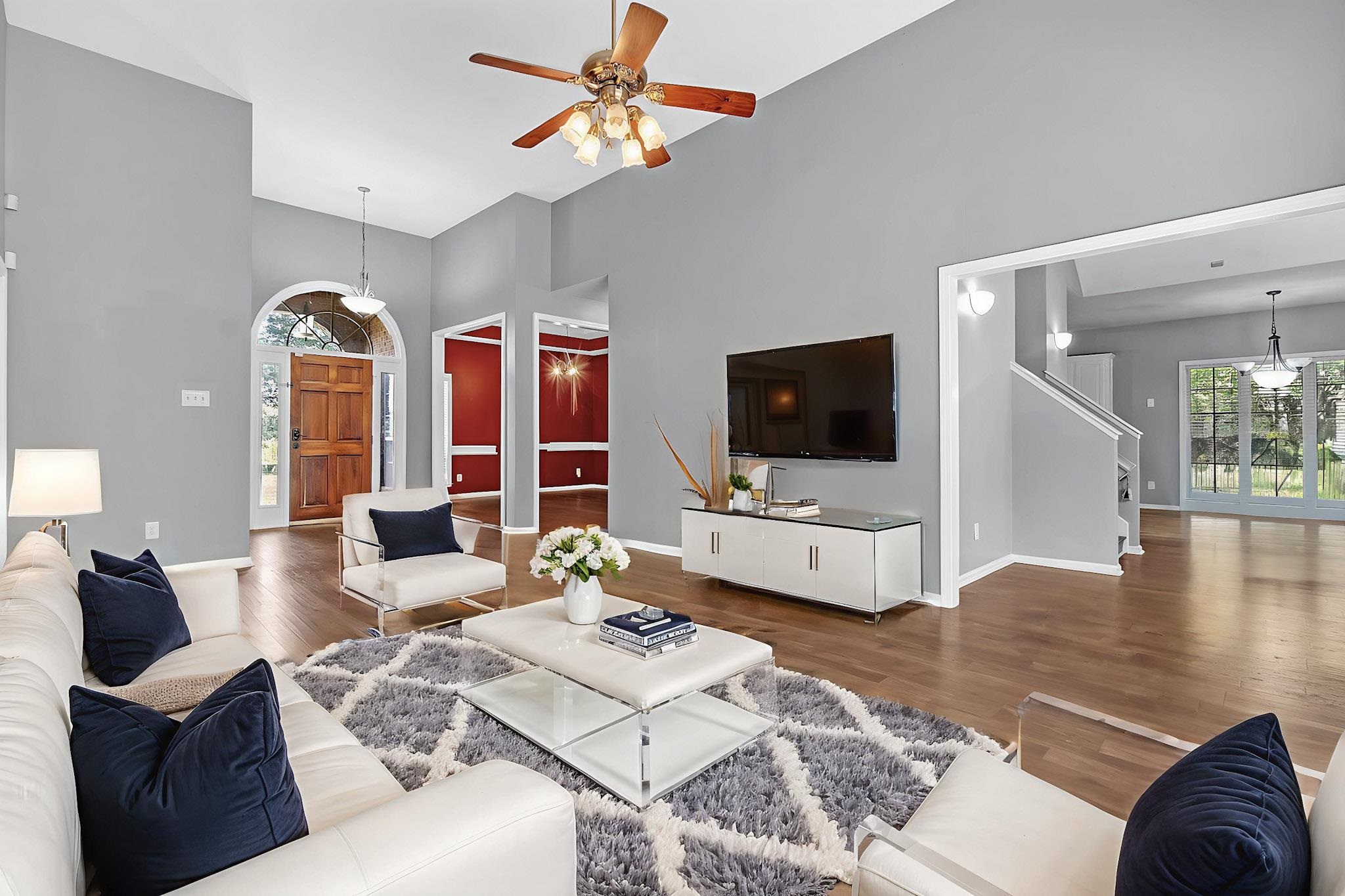 4366 Campground Road Munford, TN 38058 - Photo 4 of 40 Living room with a towering ceiling, wood finished floors, a chandelier, and a ceiling fan