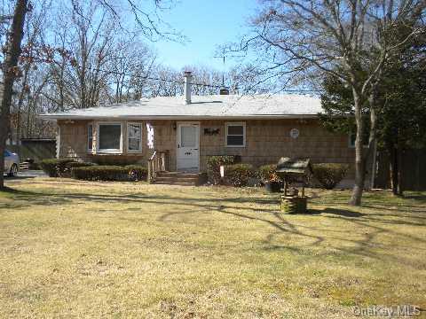 12 Half Moon Pond Road Ridge, NY 11961 - Photo 1 of 1 a view of a house with backyard porch and sitting area
