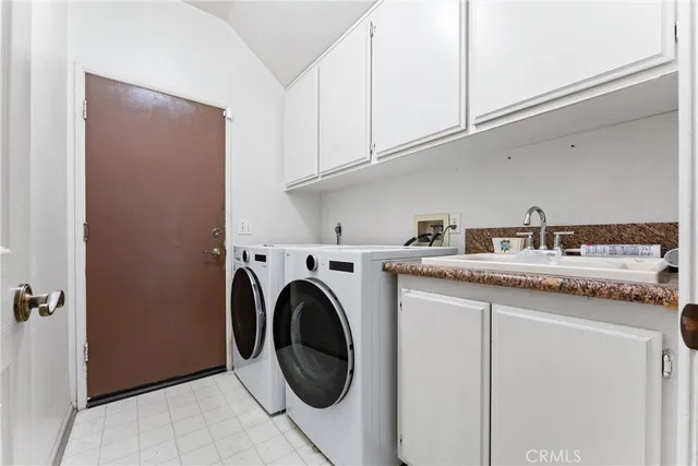 a utility room with sink dryer and washer