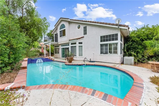 a swimming pool with outdoor seating