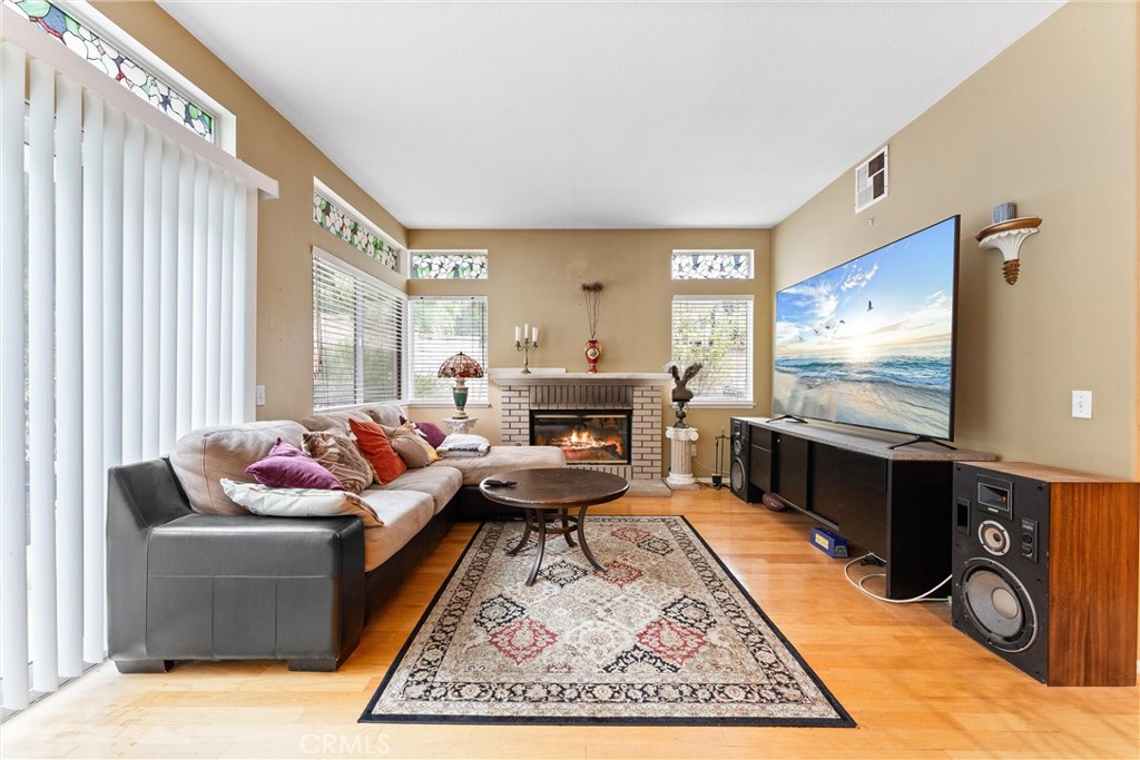13776 Monteverde Drive Chino Hills, CA 91709 - Photo 5 of 14 a living room with furniture flat screen tv and a fireplace