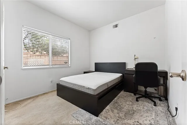 a living room with a couch and a dresser next to a window