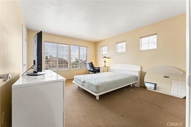 a bedroom with bed and a window