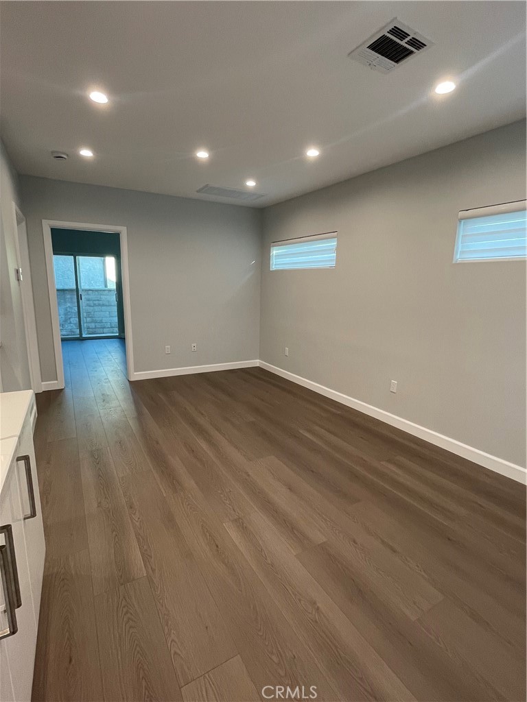1312 A Cleveland Road Glendale, CA 91202 - Photo 11 of 16 an empty room with wooden floor and windows