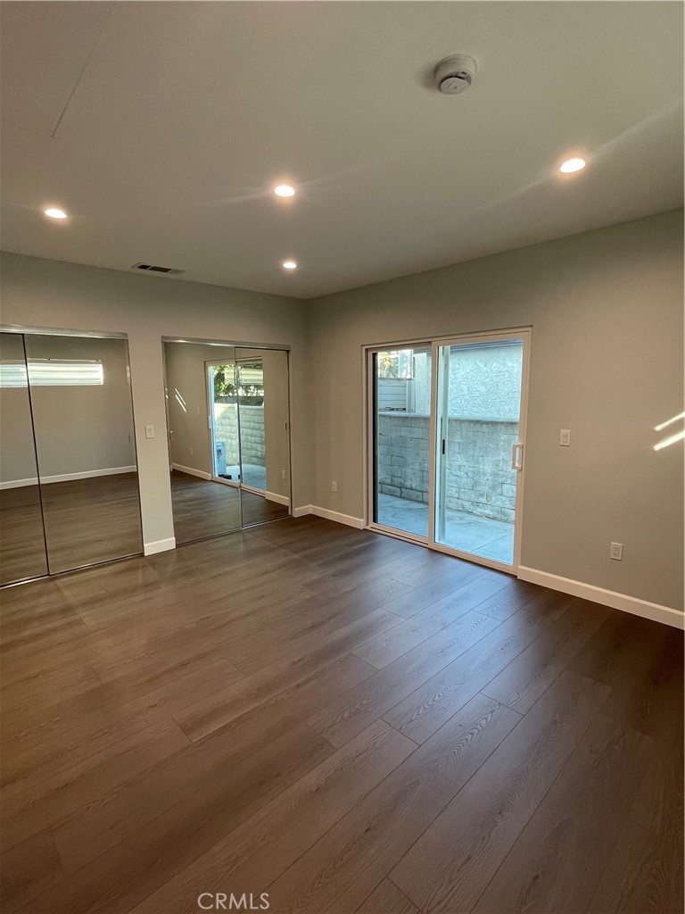 1312 A Cleveland Road Glendale, CA 91202 - Photo 12 of 16 an empty room with wooden floor and windows