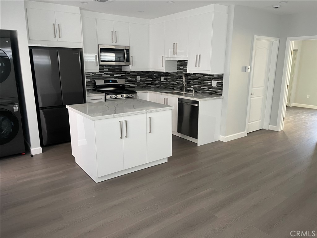 1312 A Cleveland Road Glendale, CA 91202 - Photo 3 of 16 a kitchen with stainless steel appliances a refrigerator stove and wooden floor