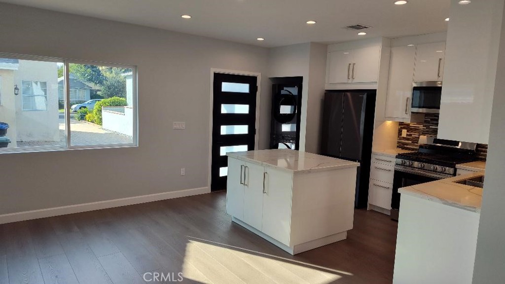 1312 A Cleveland Road Glendale, CA 91202 - Photo 4 of 16 a kitchen with a refrigerator and a stove top oven