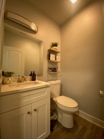 a bathroom with a toilet a sink and mirror