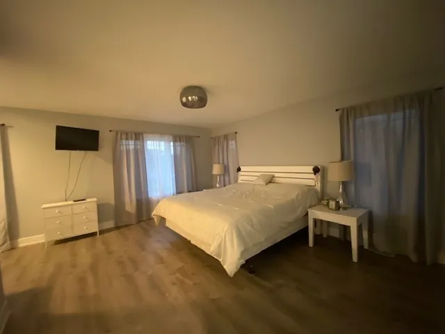 a large bed sitting in a room next to a window