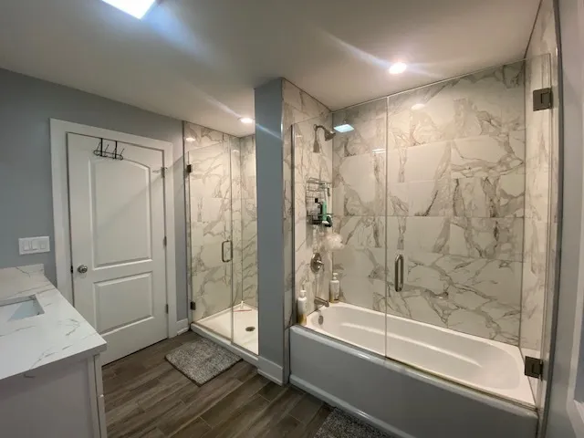 a bathroom with a shower and a bath tub