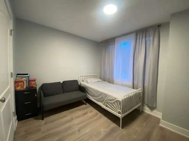 a spacious bedroom with a bed and a couch