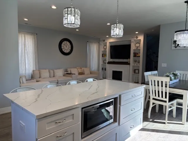 a view of a kitchen with a center island and a stove top oven