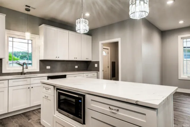 a kitchen with a sink dishwasher a stove and a microwave