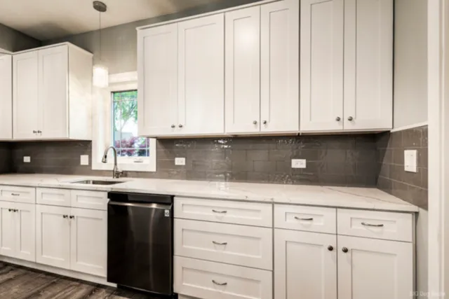 a kitchen with white cabinets and a sink