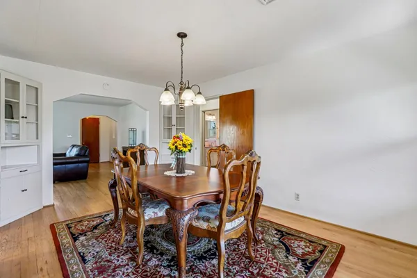 a view of a dining room with furniture and chandelier