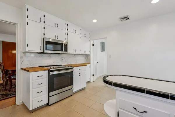 a kitchen with stainless steel appliances a stove microwave and cabinets