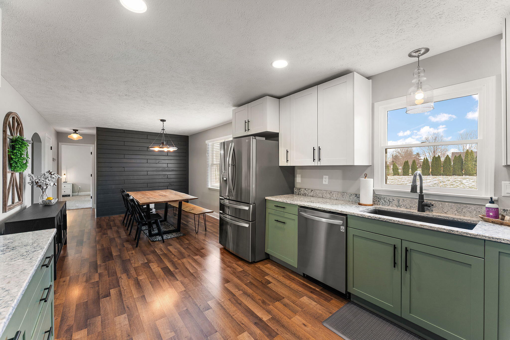 897 Jane Avenue Chesterton, IN 46304 - Photo 13 of 40 a kitchen with stainless steel appliances granite countertop a sink a stove and refrigerator