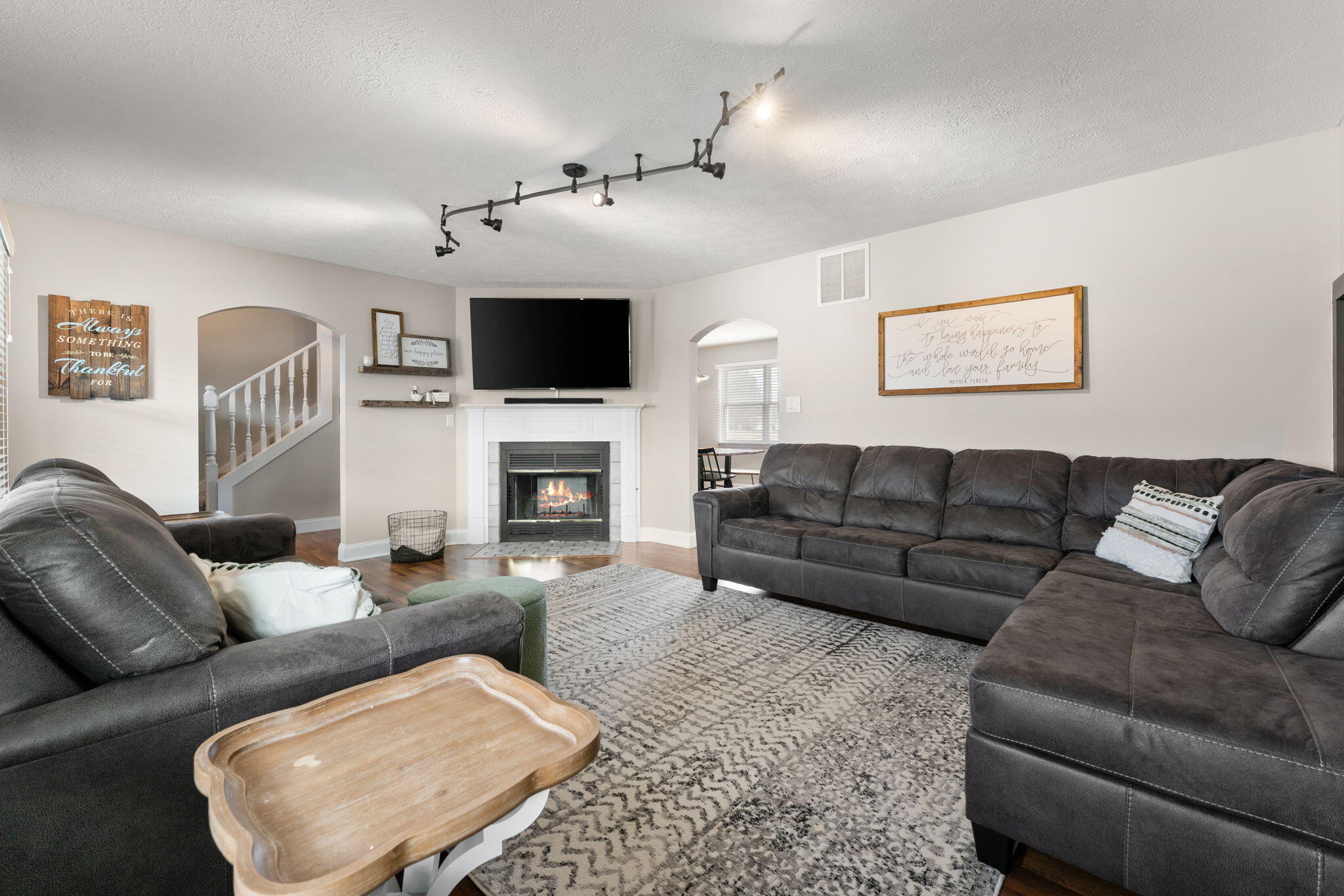 897 Jane Avenue Chesterton, IN 46304 - Photo 7 of 40 a living room with furniture a flat screen tv and a fireplace