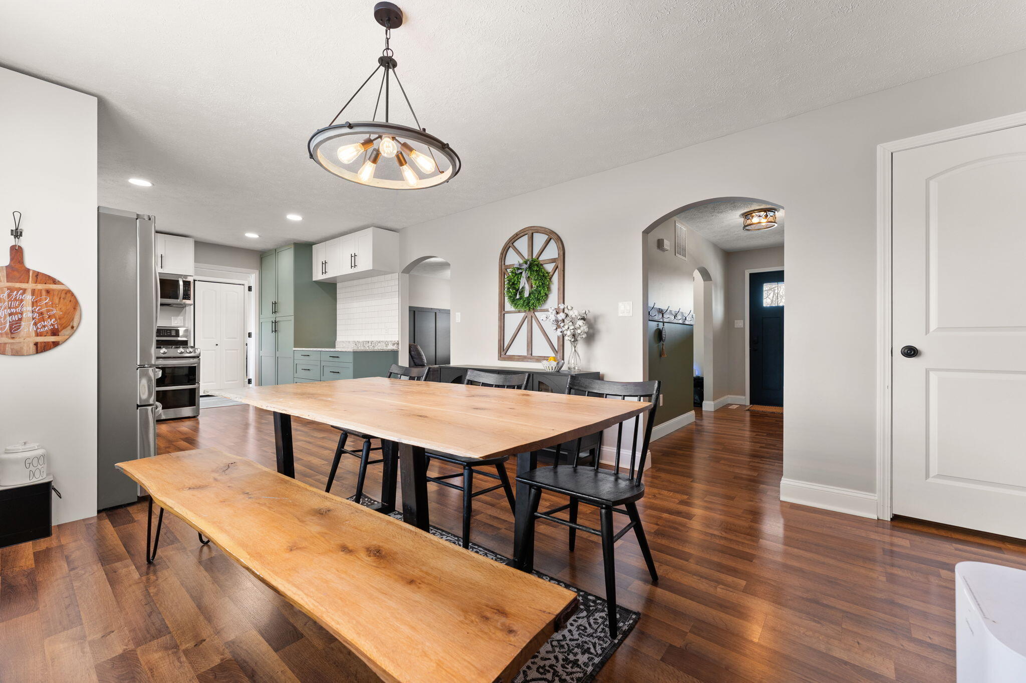 897 Jane Avenue Chesterton, IN 46304 - Photo 9 of 40 a dining room with wooden floor a chandelier a wooden table and chairs