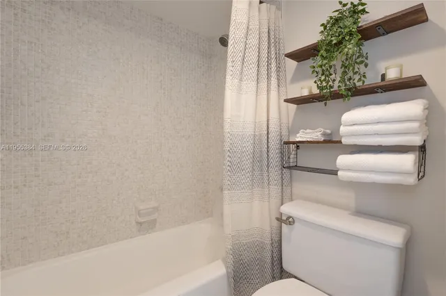 a bathroom with a toilet and a bathtub