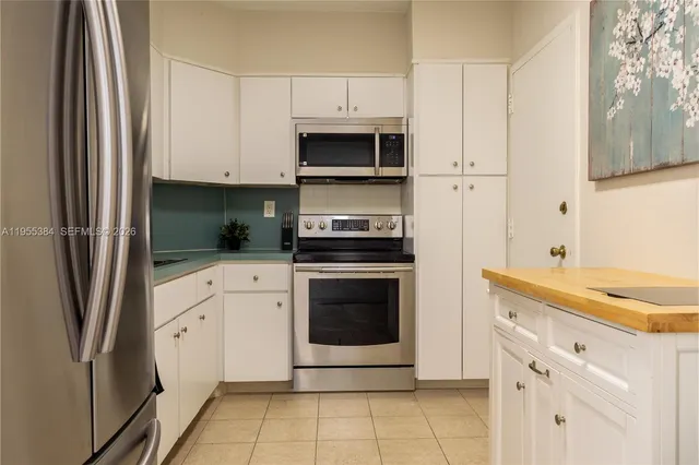 a kitchen with cabinets stainless steel appliances and a counter space