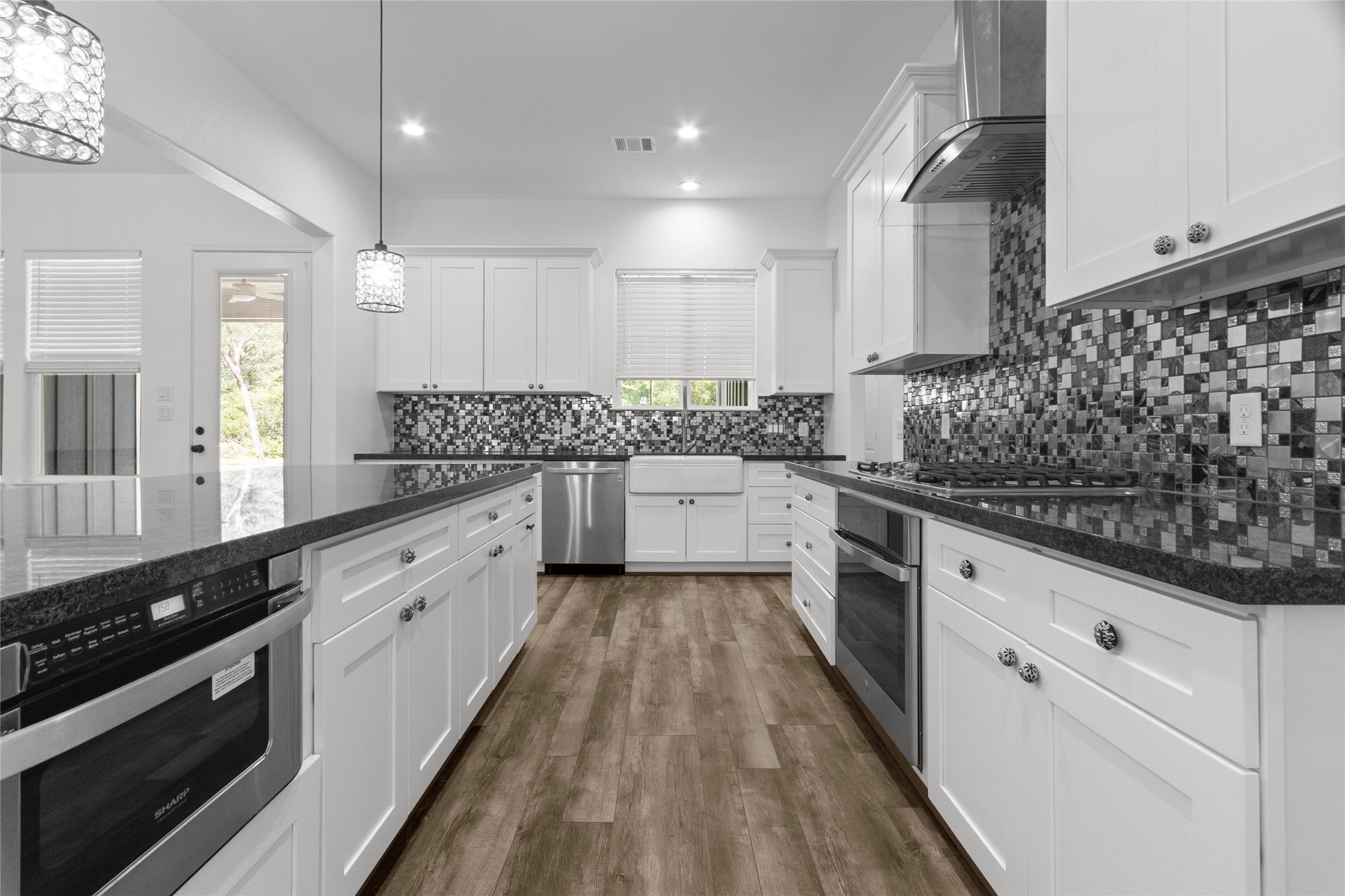 16735 Azalea Lane Plantersville, TX 77363 - Photo 10 of 44 a large kitchen with a sink and cabinets