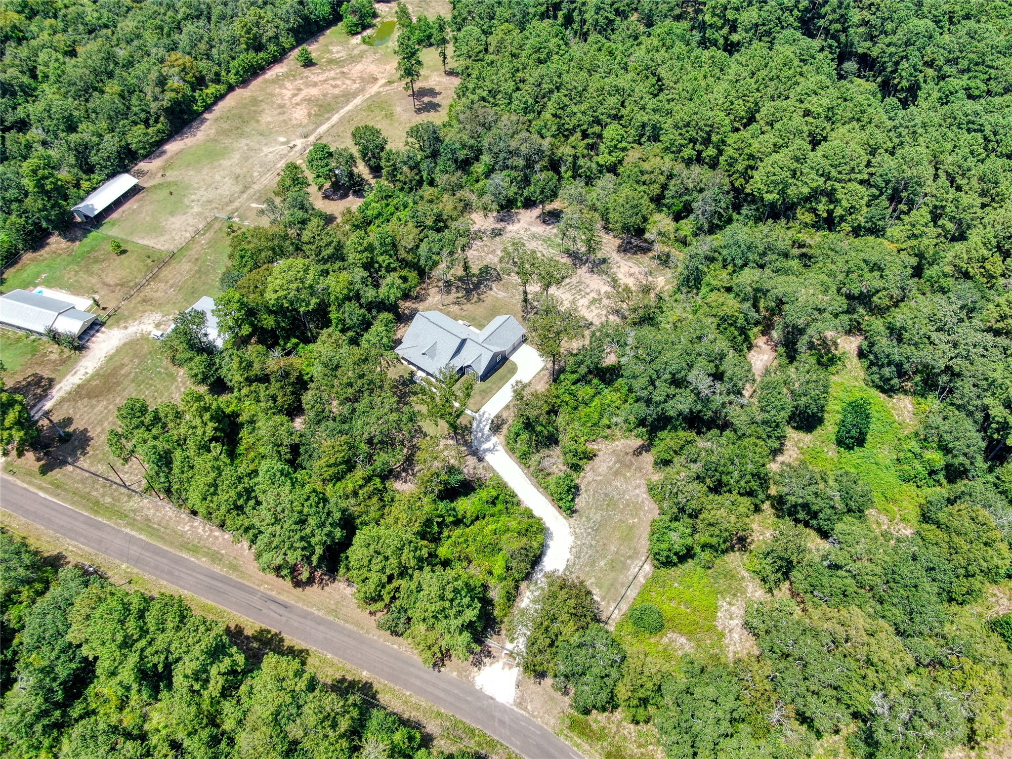 16735 Azalea Lane Plantersville, TX 77363 - Photo 33 of 44 an aerial view of residential house with outdoor space and trees all around