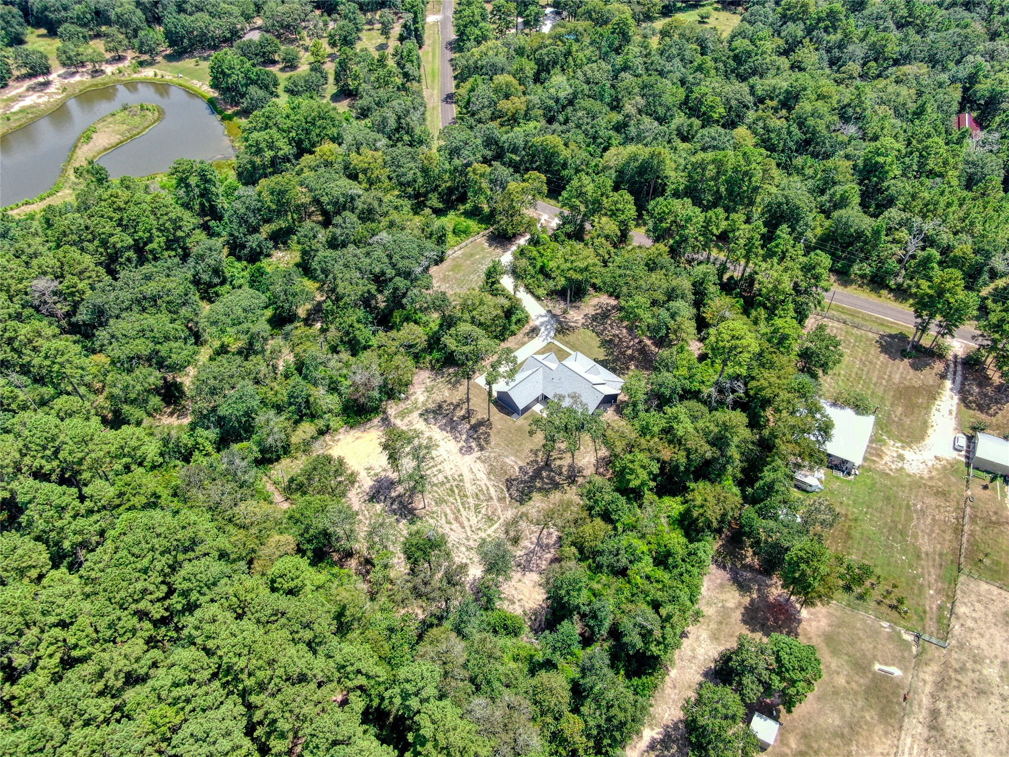 16735 Azalea Lane Plantersville, TX 77363 - Photo 37 of 44 an aerial view of residential house with outdoor space and trees all around