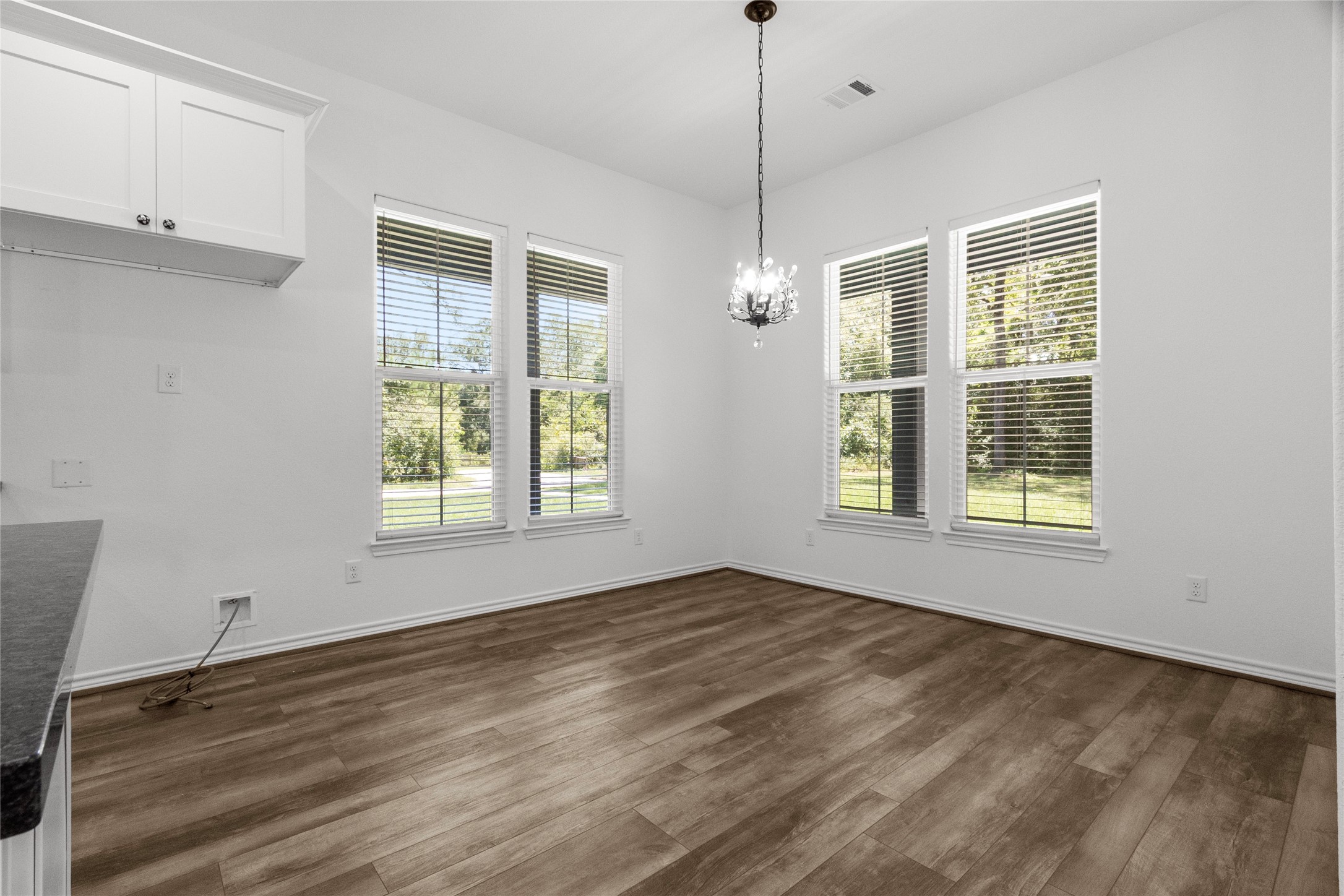 16735 Azalea Lane Plantersville, TX 77363 - Photo 7 of 44 a view of an empty room with a window and wooden floor