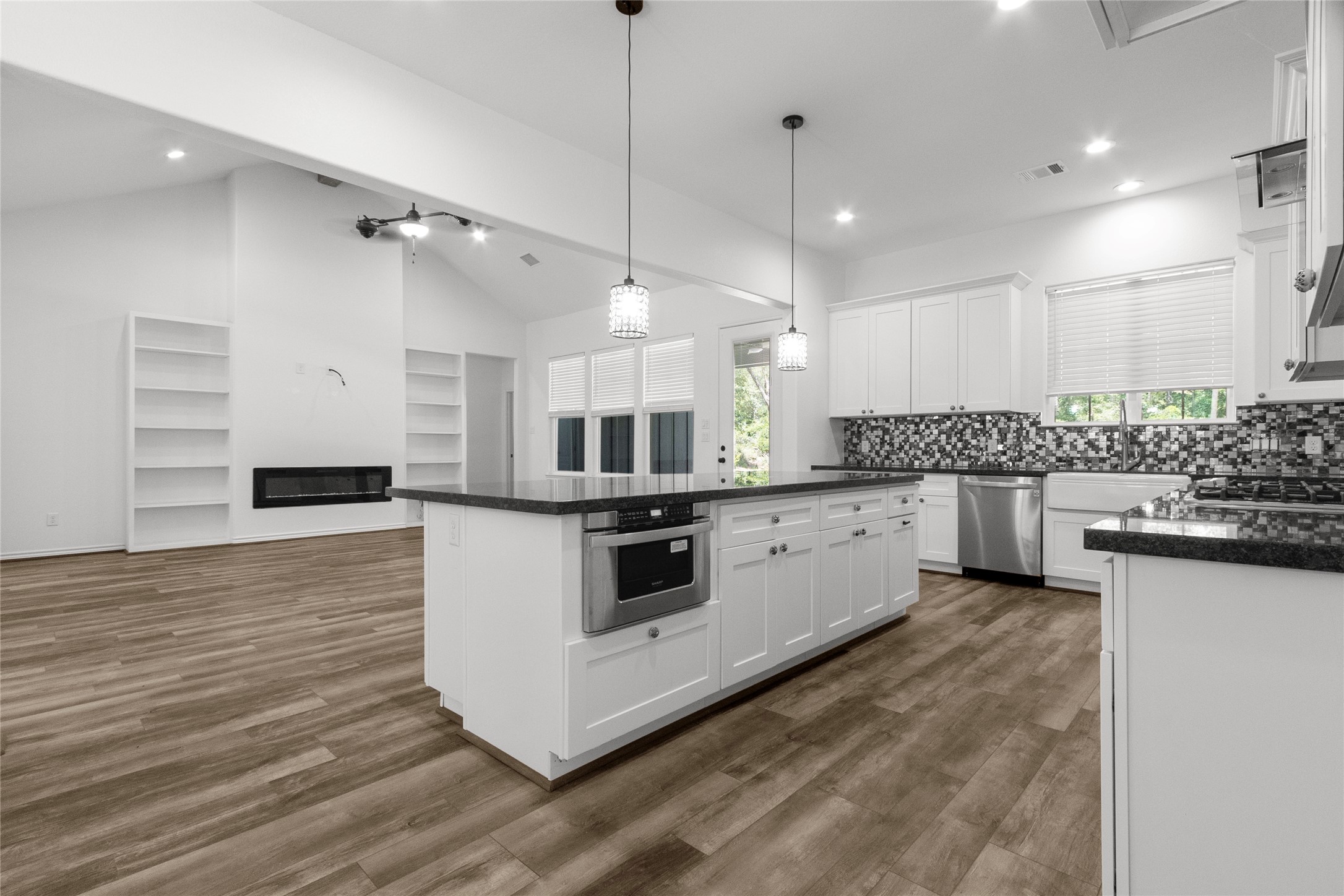 16735 Azalea Lane Plantersville, TX 77363 - Photo 9 of 44 a large white kitchen with stainless steel appliances kitchen island a large counter top a stove a sink and a refrigerator