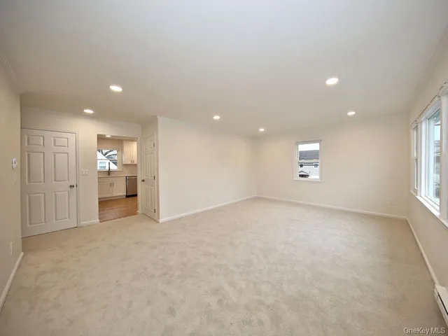 an empty room with a empty space and windows