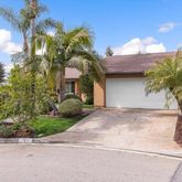 a view of a house with a yard and garage