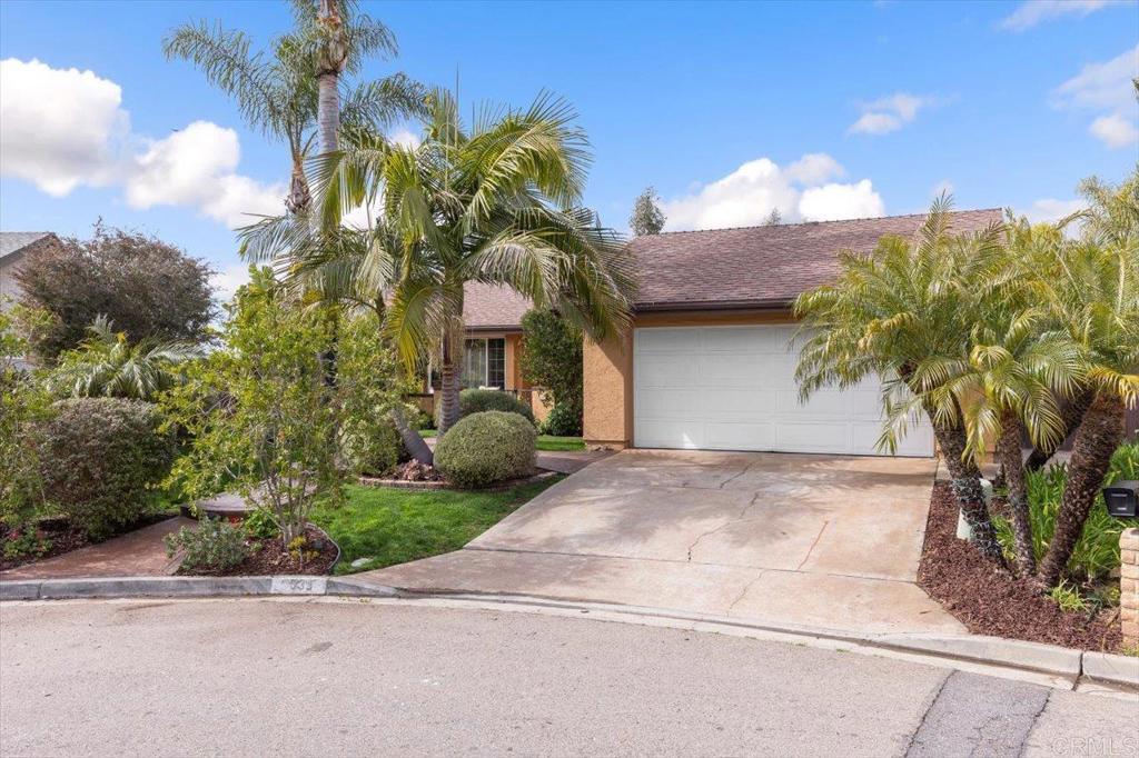 a view of a house with a yard and garage