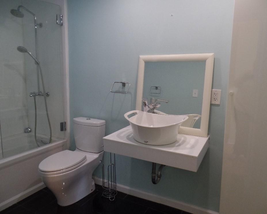 320 Fort Duquesne Boulevard, Unit 24M Pittsburgh, PA 15222 - Photo 6 of 40 a bathroom with a sink toilet and shower