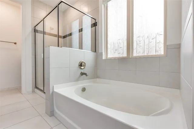 a white bath tub sitting next to a window
