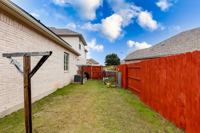 a backyard of a house with table and sofas