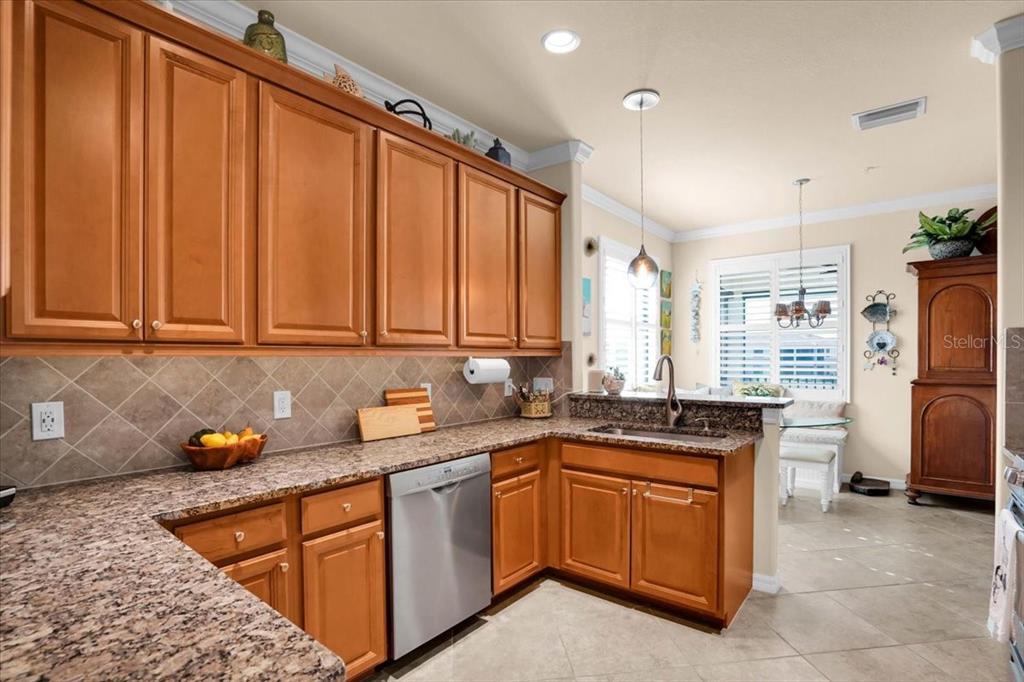 20201 Ragazza Circle, Unit 201 Venice, FL 34293 - Photo 21 of 58 a kitchen with stainless steel appliances granite countertop a sink stove and refrigerator
