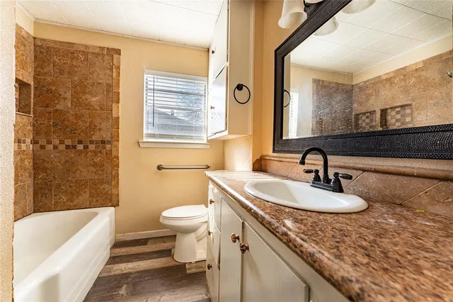 a bathroom with a sink a toilet and a bathtub