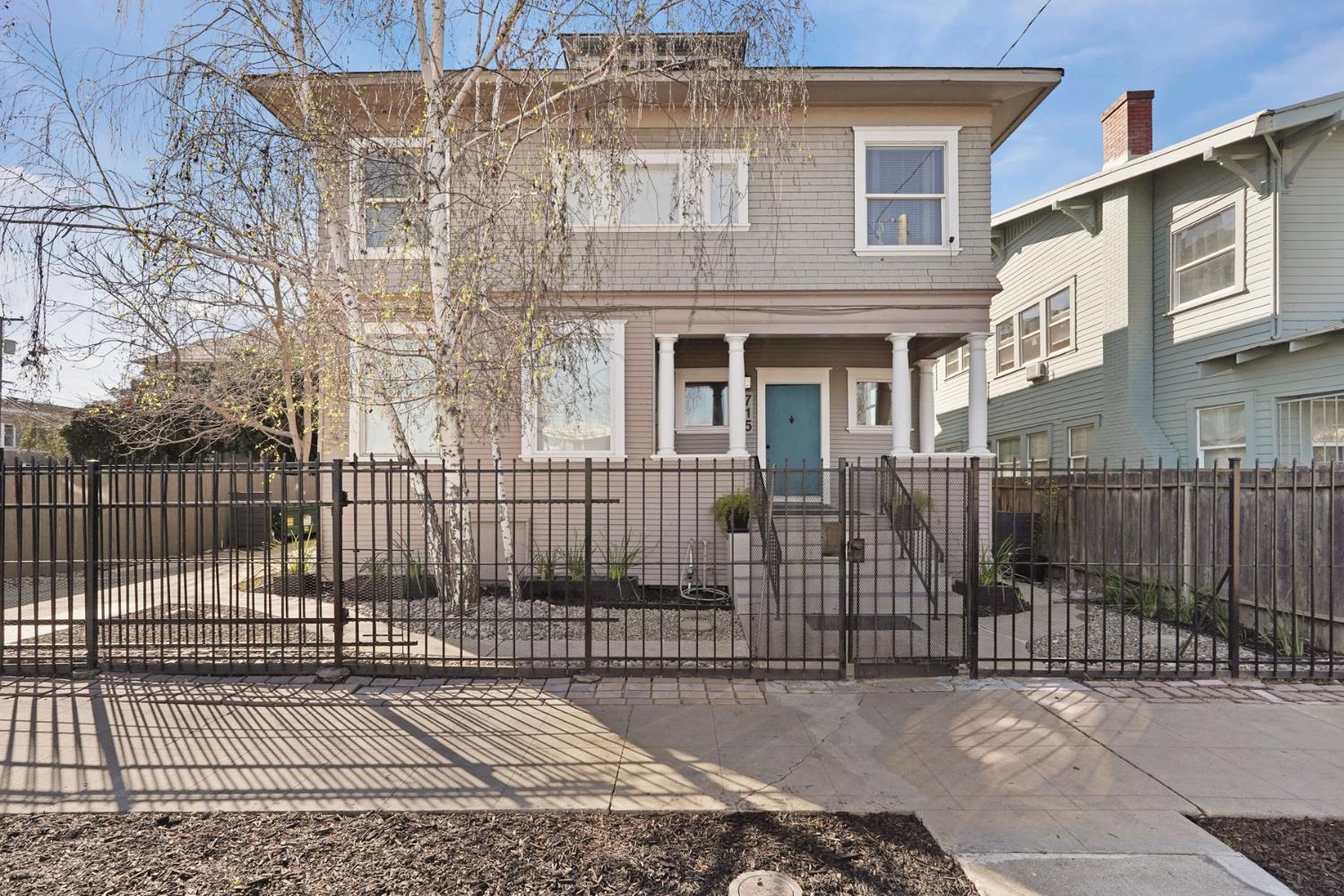 715 North Sutter Street Stockton, CA 95202 - Photo 1 of 51 a view of a brick house with a small yard and wooden fence