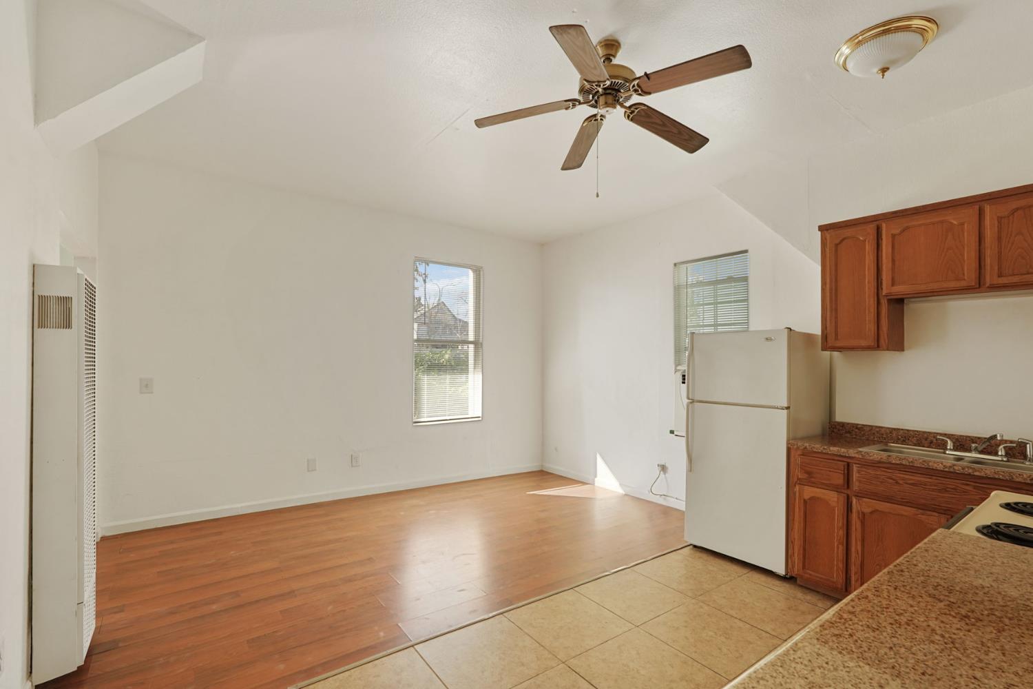 715 North Sutter Street Stockton, CA 95202 - Photo 11 of 51 a view of a livingroom with a ceiling fan and wooden floor