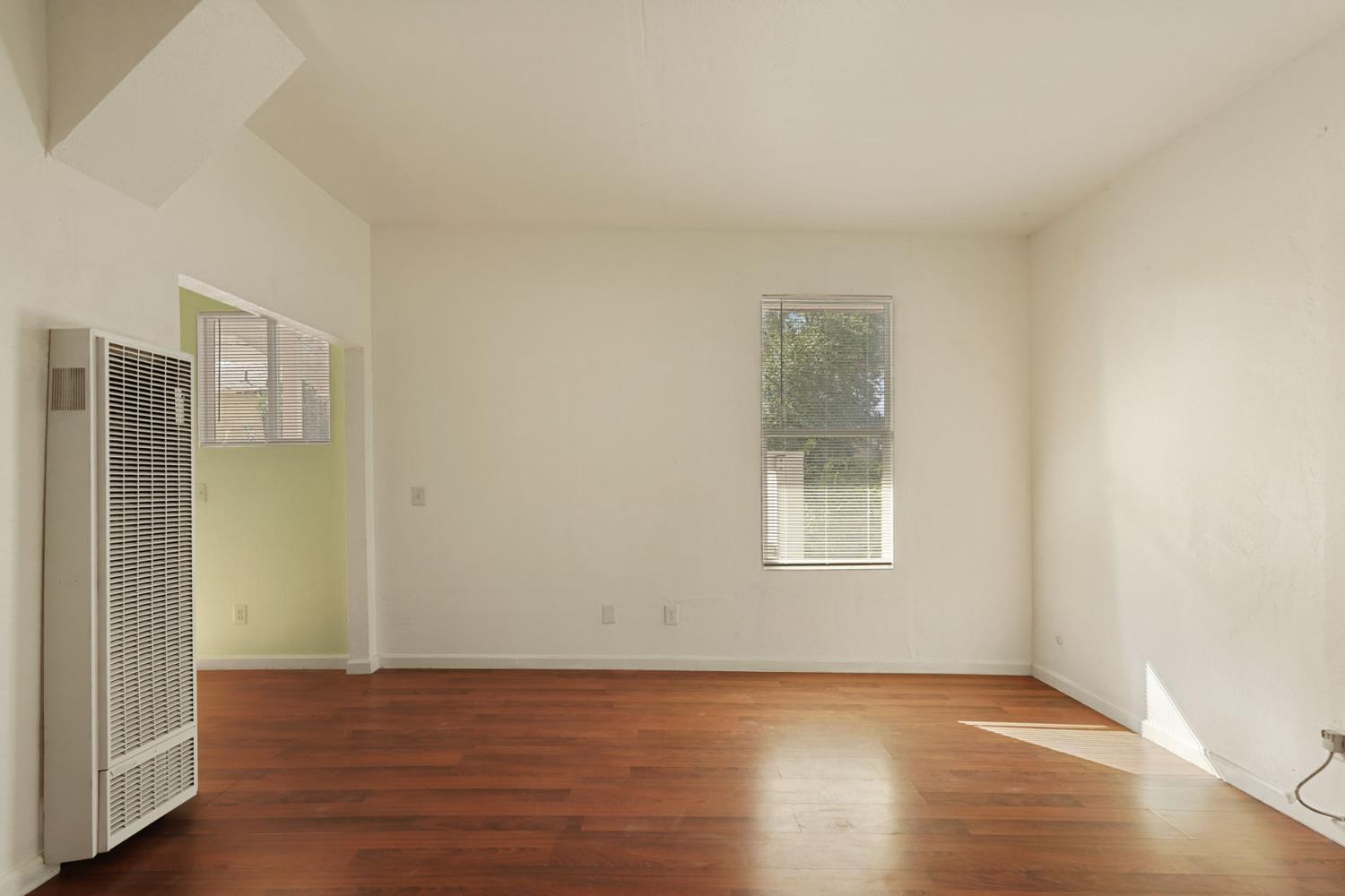 715 North Sutter Street Stockton, CA 95202 - Photo 12 of 51 a view of an empty room with wooden floor and a window